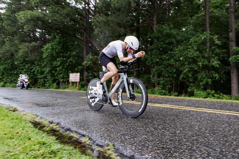 A person riding a bike on a road

Description automatically generated